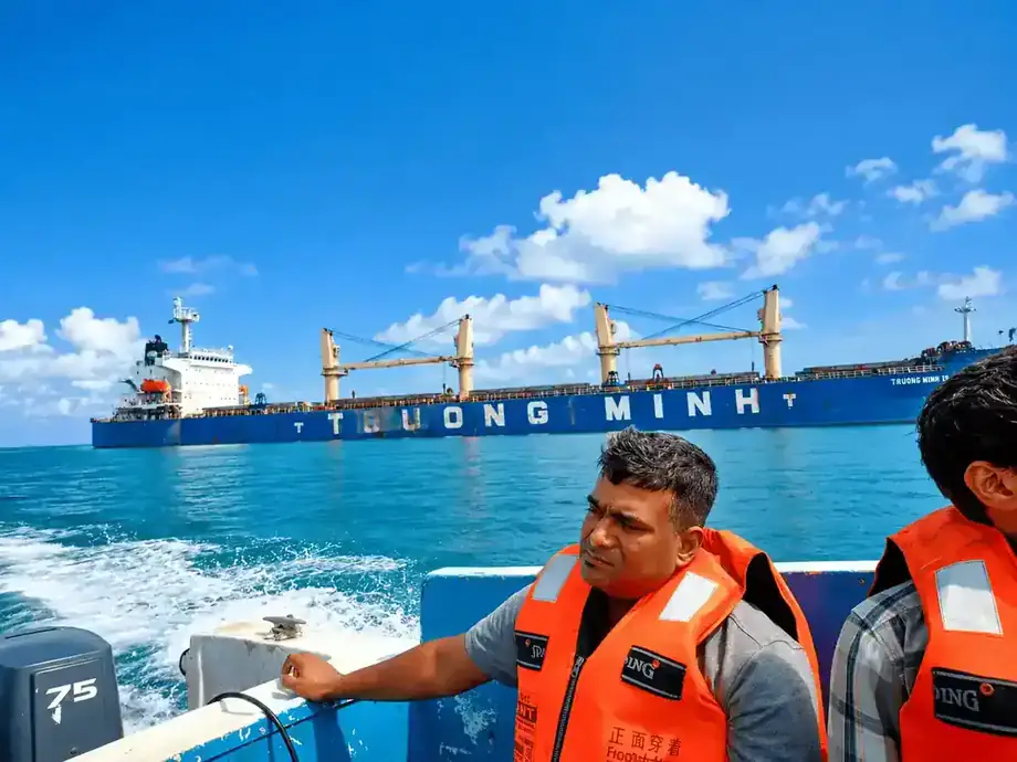 Ship crew transfer launch operating near a cargo vessel at Chittagong outer anchorage
